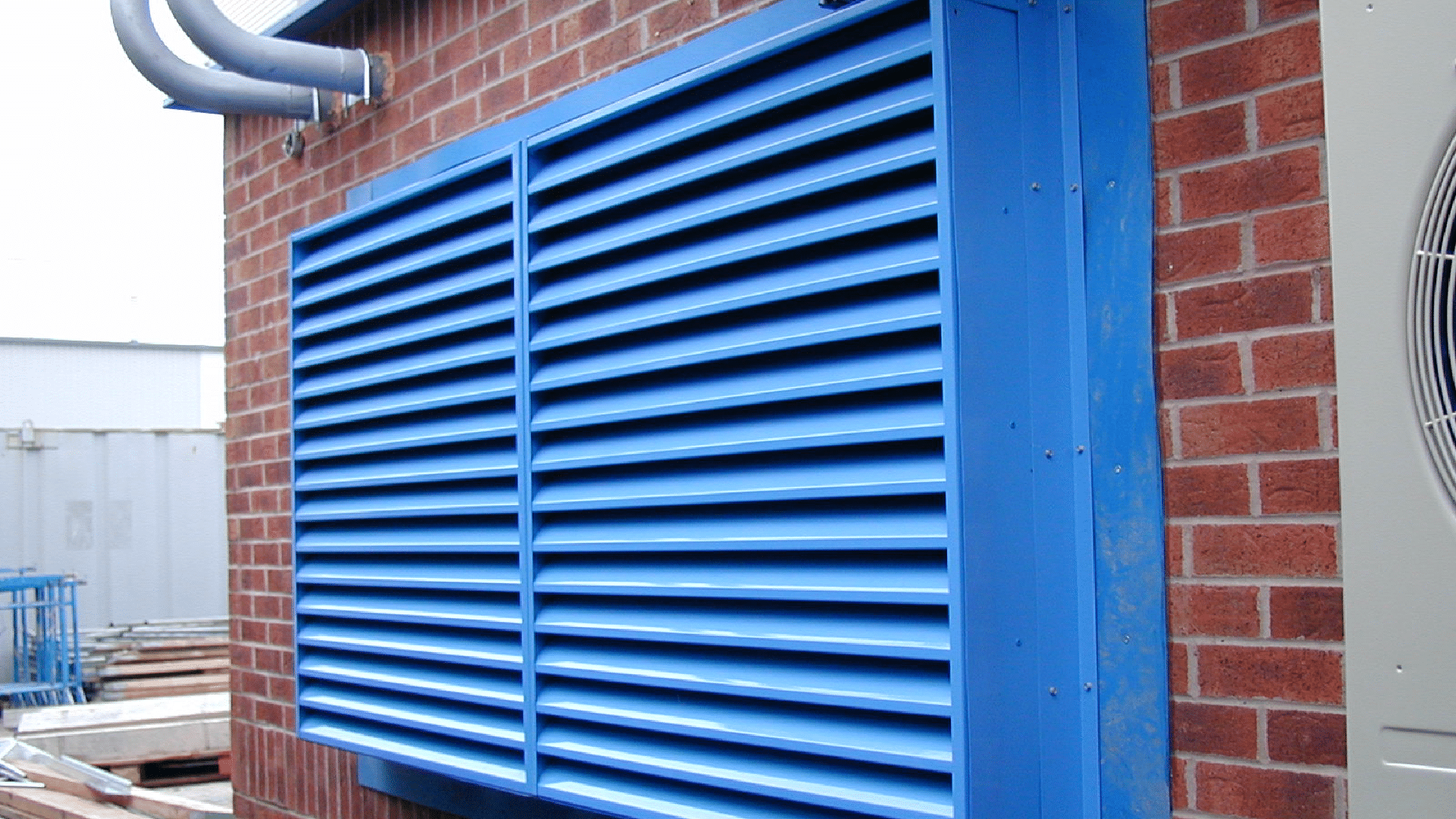 Acoustic Louvres & Louvred Barriers blue vent on the side of a building