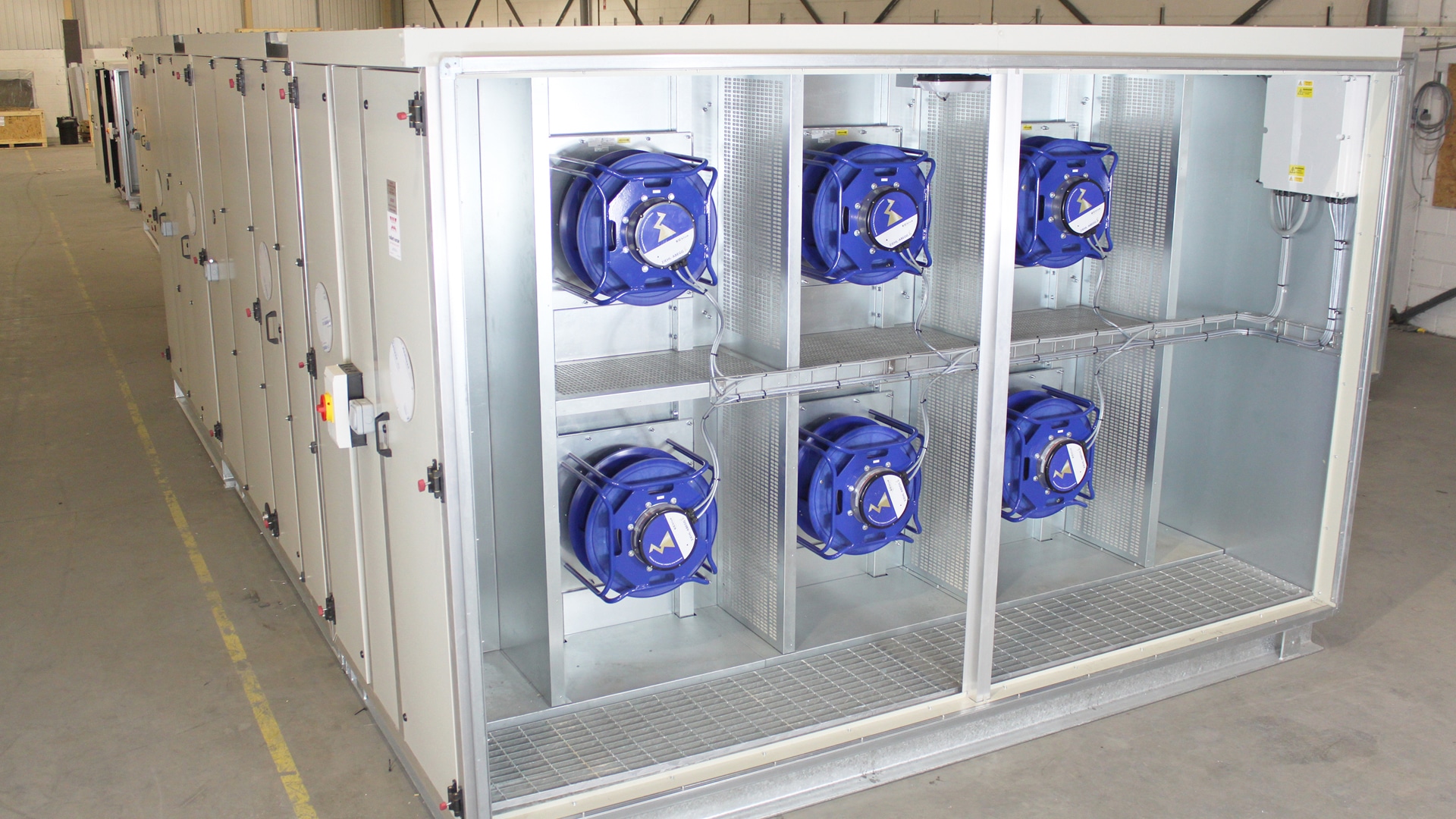 an Air Handling Unit showing a wall of fans. Six blue fans within an AHU