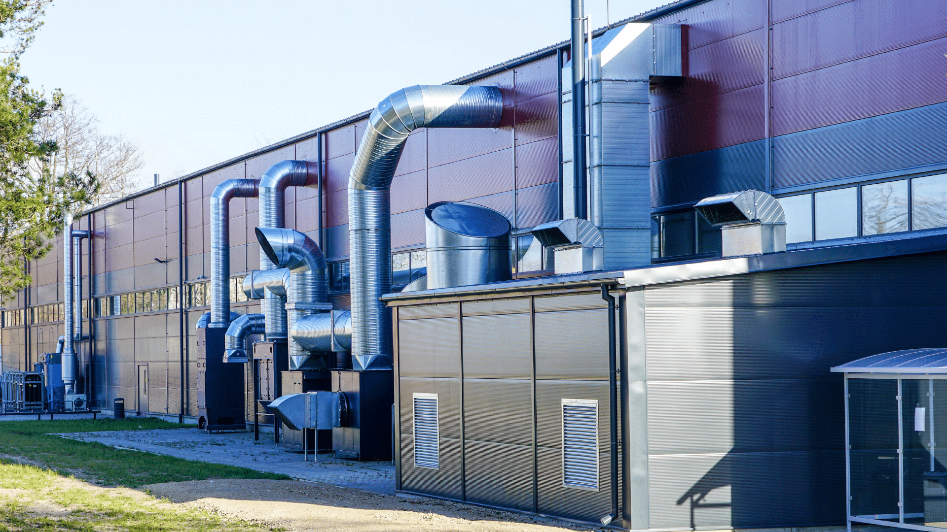 A red building showing external Ductwork, AHU, and Acoustic Solutions